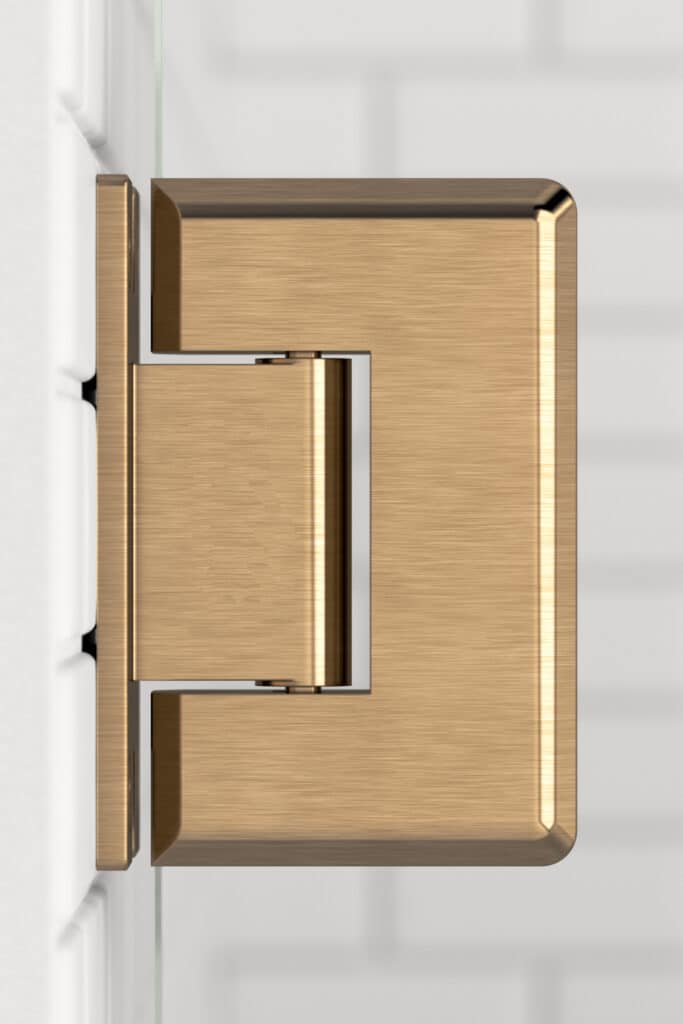Modern brass handle on a white shower door.