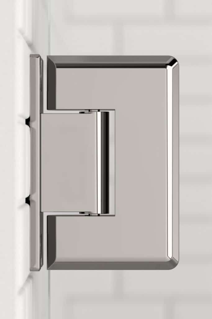 Stainless steel square towel ring mounted on a white wall beside shower doors.