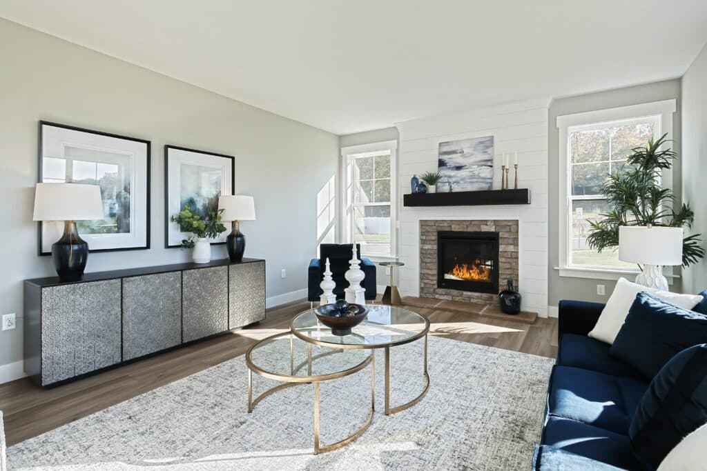 A bright and modern living room with multiple fireplaces, comfortable seating, and tasteful decor.