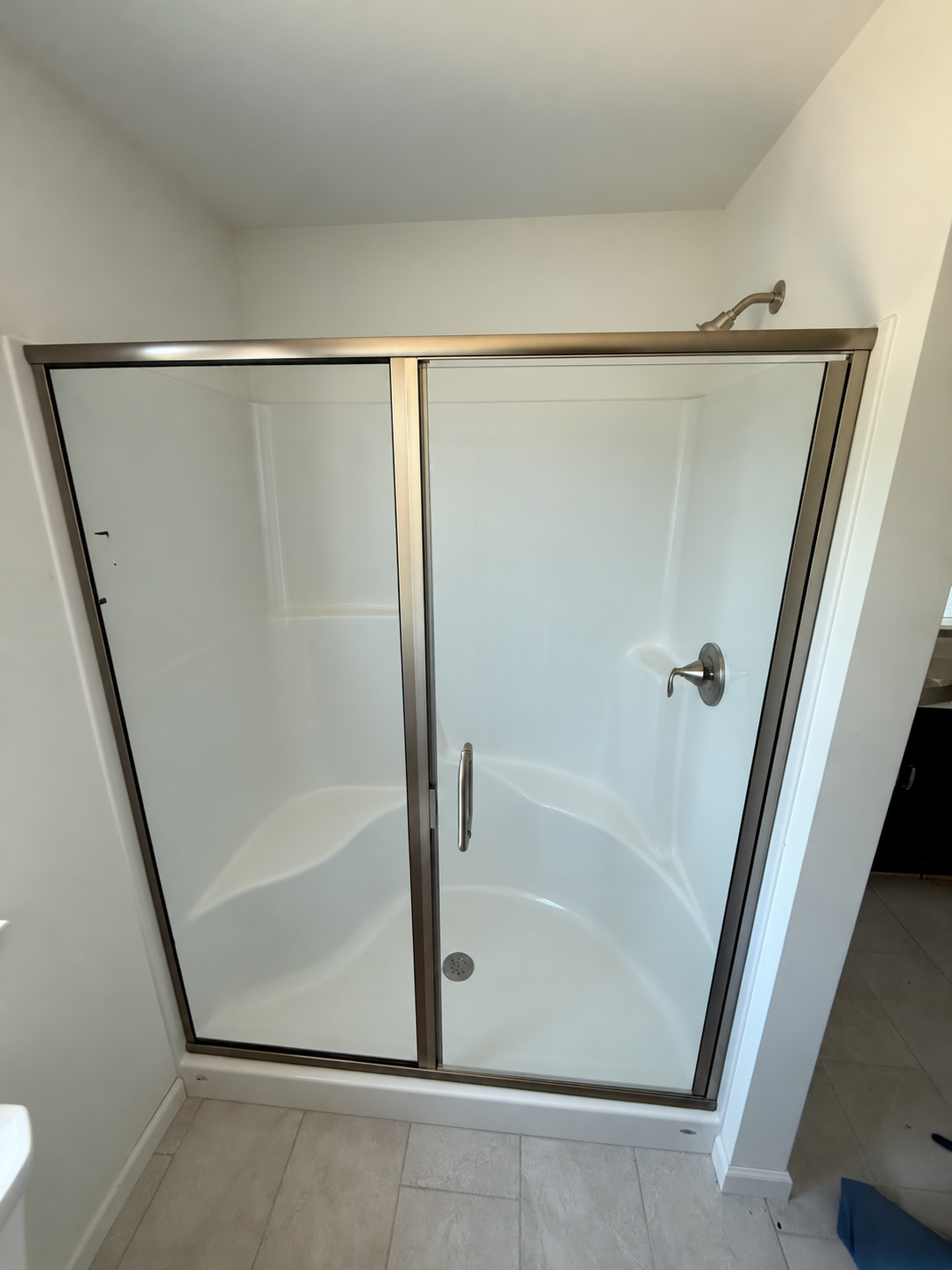 Semi-frameless shower door with brushed nickel hardware | Crystal View Shower Doors